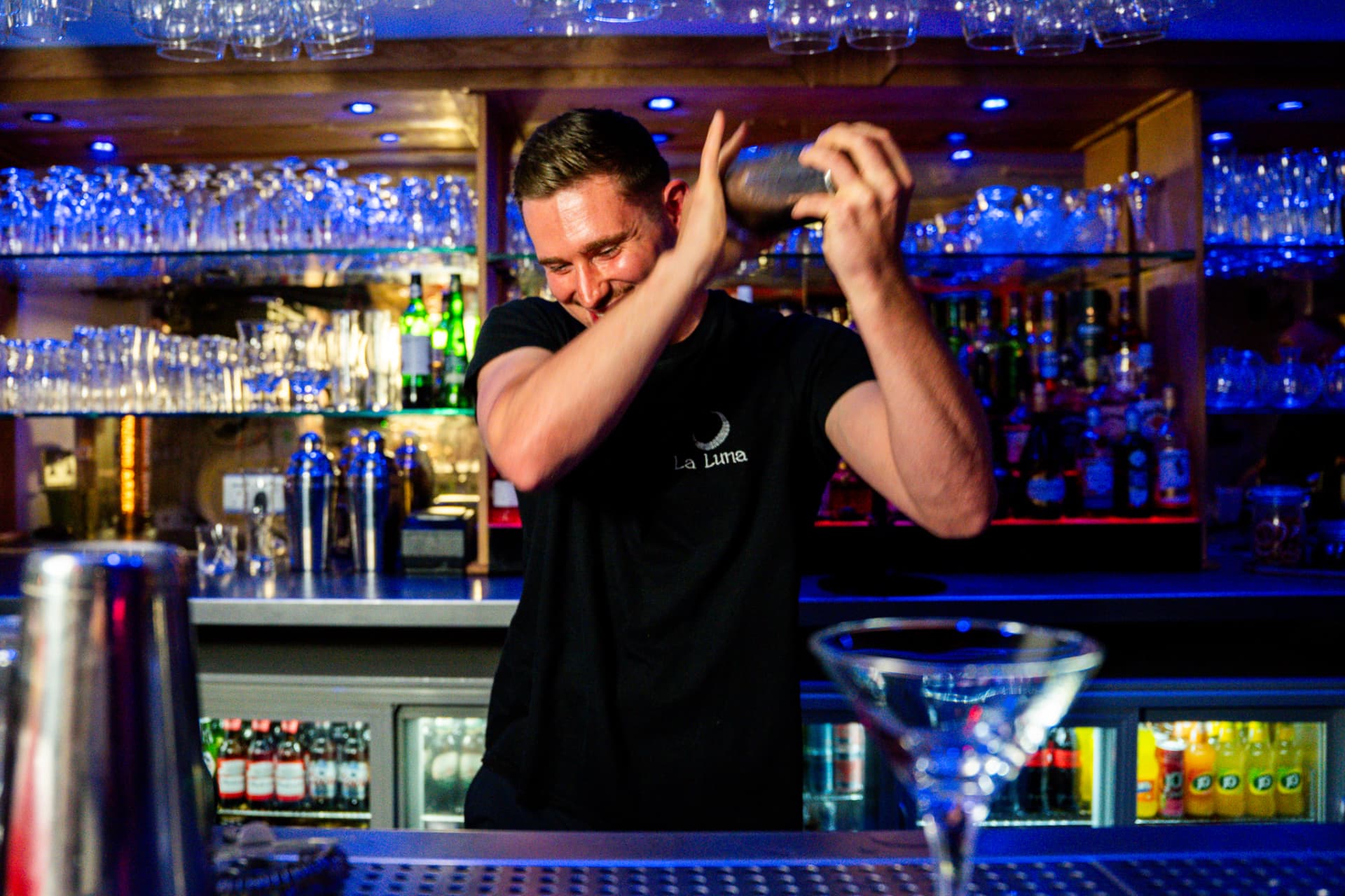 Bartender shaking a cocktail behind the bar in the Luna Lounge at La Luna, Talbot Green, near Pontyclun
