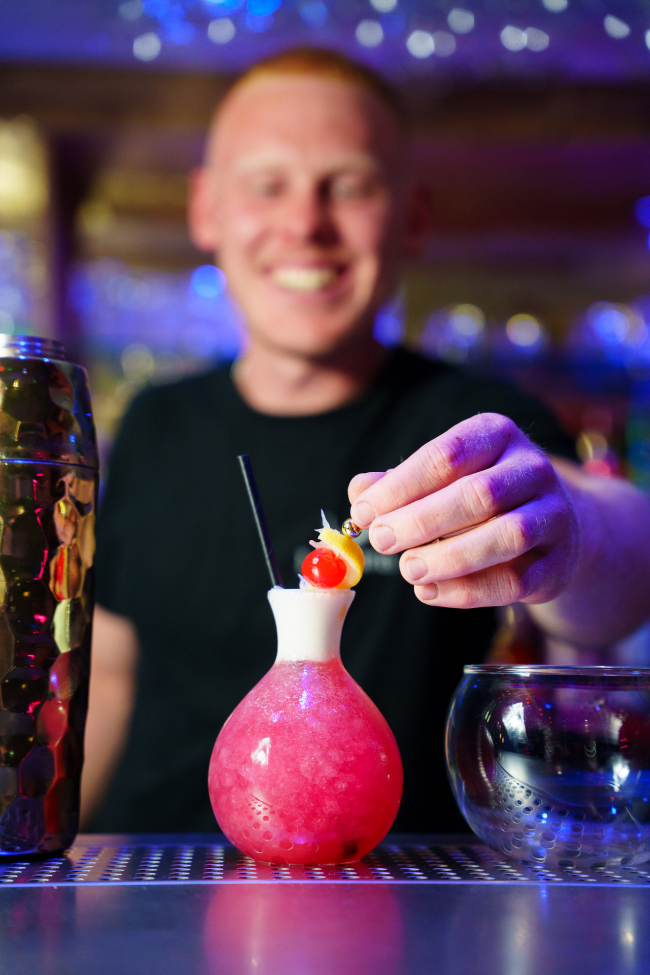 A bartender garnishing a signature La Luna cocktail