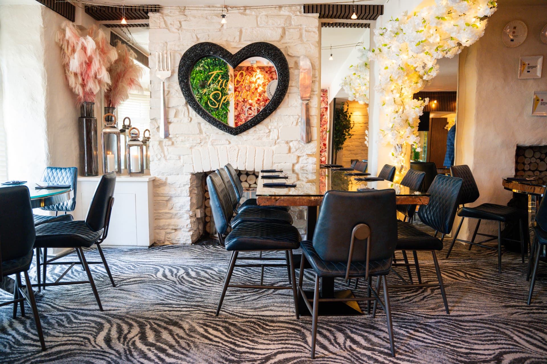 The True Love Spoon private dining room — heart mirror, white brick walls and intimate seating