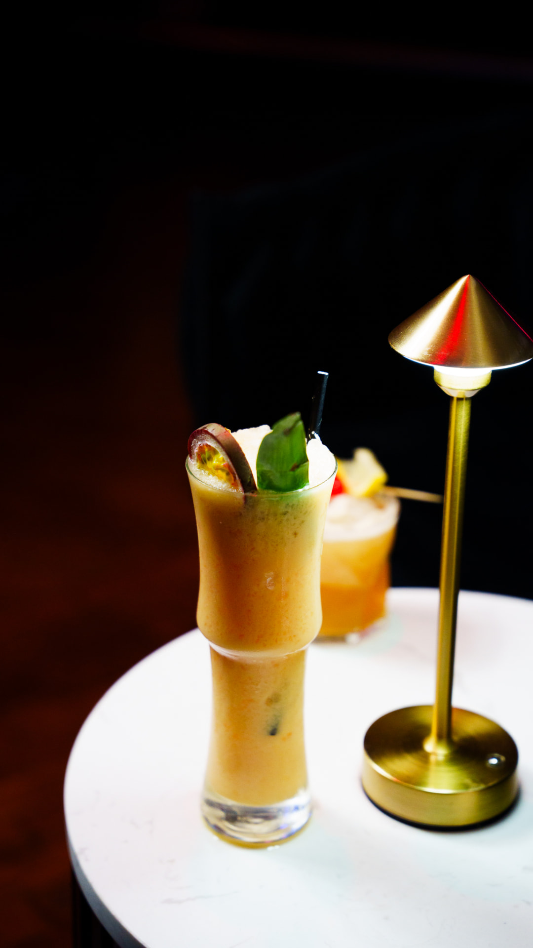 Passionfruit cocktail with basil garnish