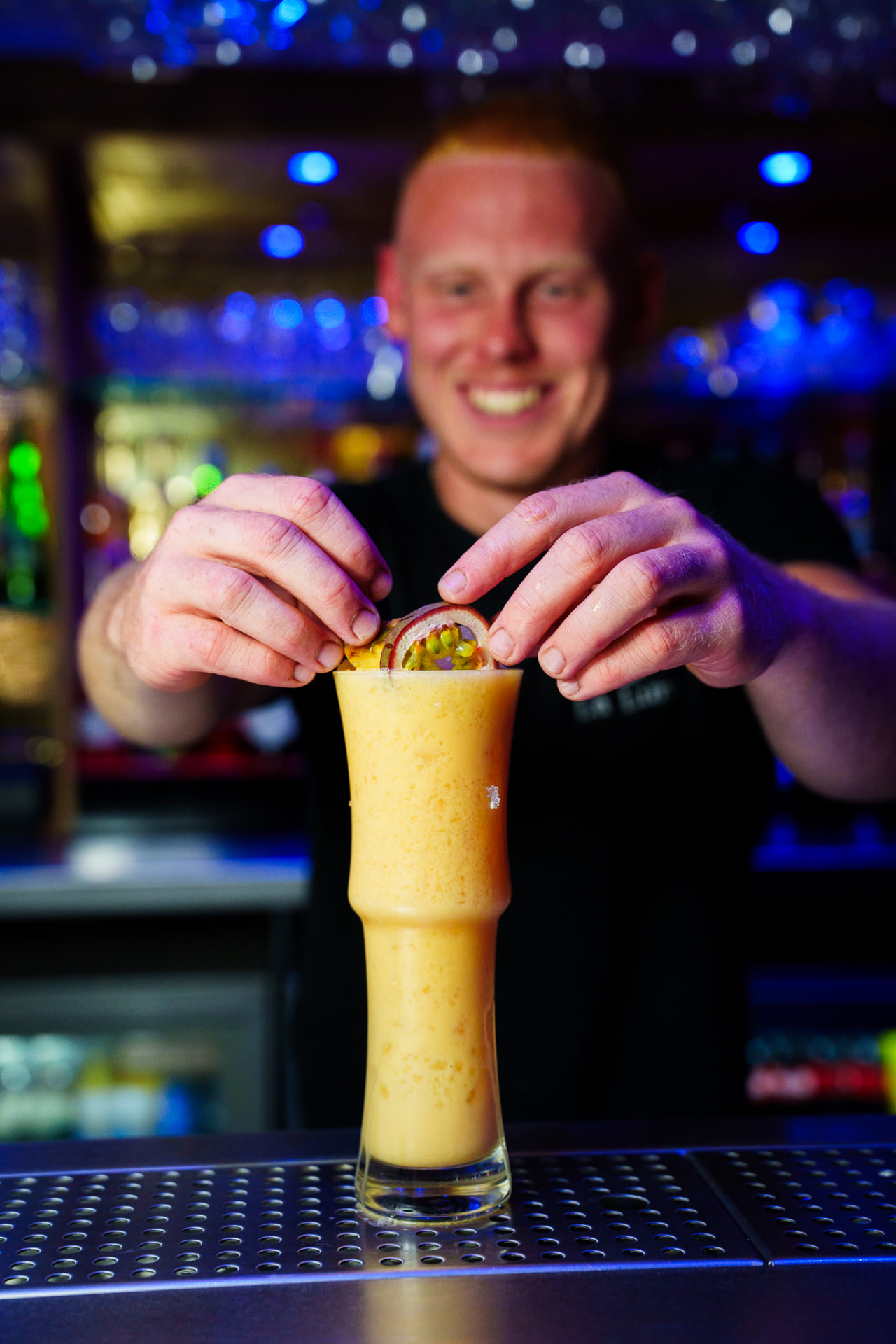 A bartender garnishing a La Luna signature cocktail