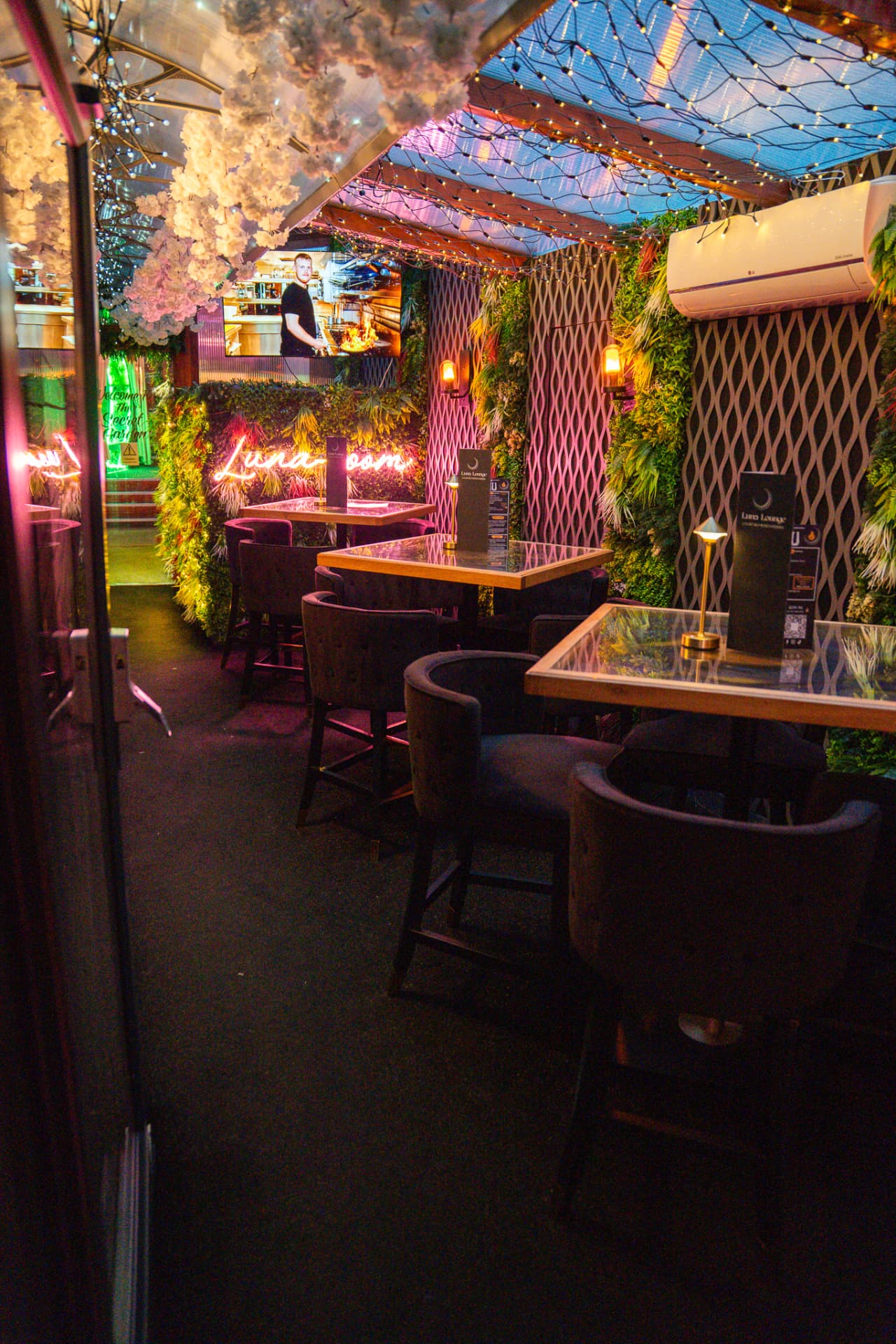 The Luna Lounge — mood-lit private dining space with neon signage and fairy lights